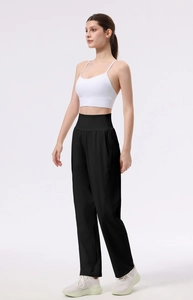 Detail view of high waist wide leg yoga pants paired with a white sports bra top