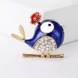 Detailed view of bird brooch with blue enamel wings and sparkling crystal belly