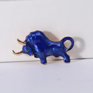 Macro shot of creative enamel bull brooch with deep blue finish and golden horns