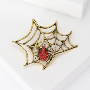 Gothic style spider web brooch with red rhinestones in antique gold finish for Halloween