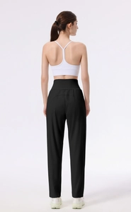 Rear view of high-waisted black yoga pants with curved back seams for body shaping