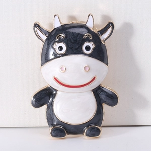 Detailed macro view of the cute cow enamel brooch showing black and white patterns