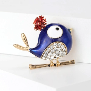 Cute bird brooch with blue enamel, red flower details and sparkling white crystals