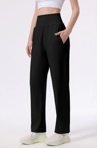 Detail view of high-waisted black yoga pants with invisible side pockets and matte texture