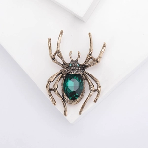 Vintage Spinnenbrosche in Gold mit großem grünen Kristall und Skelettbeinen für Halloween