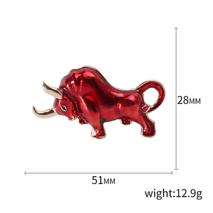 Red enamel bull brooch in gold-tone metal, dimensions 51mm by 28mm on white background