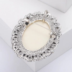 Detailed back view of vintage silver brooch with multifunctional pin and pendant clasp