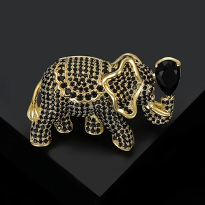 Macro shot of gold-plated elephant brooch with micro-paved black zircons and pear-cut stone