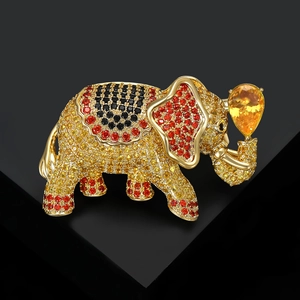 Macro shot of gold elephant brooch featuring intricate colorful zircon pavé detailing