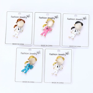 Set of five nurse-themed enamel brooches with opal cat eye stones on a white background
