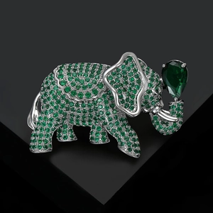 Detailed macro view of elephant brooch with micro-paved green stones and pear-shaped gem