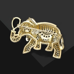 Detail of elephant brooch back showing gold plated hollow metal and safety pin clasp