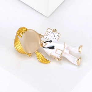 Detailed view of nurse brooch with yellow opal head and white enamel professional suit