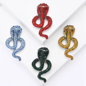Elegant cobra snake brooches with colorful rhinestones in four vibrant finish options