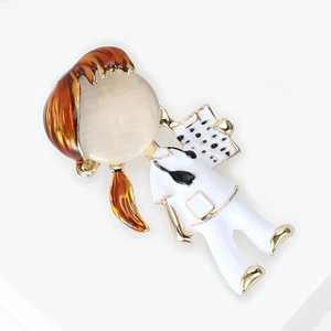 Detail of a gold alloy nurse brooch with cream cat-eye stone and brown enamel hair