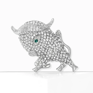 Elegant silver-toned bull brooch with pavé-set crystals and a green gemstone eye