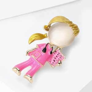 Detailed view of nurse brooch with pink enamel outfit, opal head and gold stethoscope