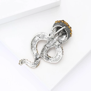 Detail view showing the secure pin closure on the back of the vintage alloy snake brooch