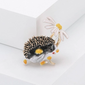 Detailed view of hedgehog brooch with white daisy on a white geometric block