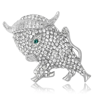 Bull brooch in silver alloy with white rhinestones and a green gemstone eye on white background
