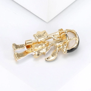 Close-up of brooch back view with gold metal pin and detailed enamel finish