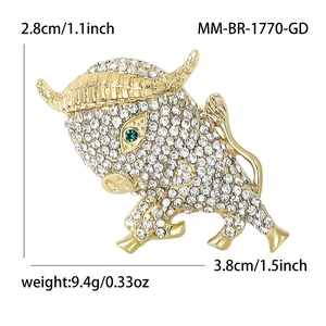 Bull lapel pin with white rhinestones and green gem eyes in gold-plated alloy