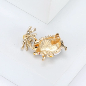Close-up of the alloy brooch back showing golden plating and secure pin closure detail