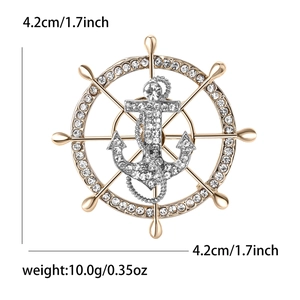 Golden ship wheel and silver anchor brooch with crystals, measures 4.2cm by 4.2cm