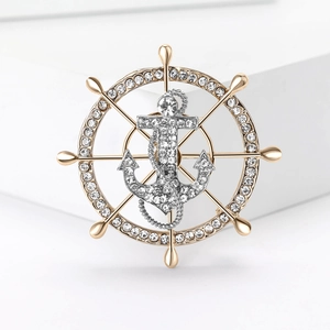 Marine anchor and helm brooch with rhinestones on a white minimalist platform