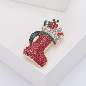Sparkling Christmas stocking brooch with red and green rhinestones in gold alloy finish