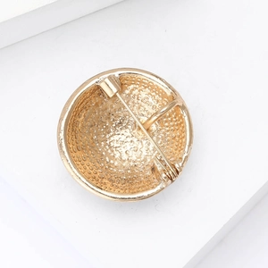 Close-up of the light gold alloy enamel soccer brooch back with rotary safety pin detail