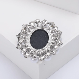 Detailed back view of the alloy cameo brooch showing the metal pin closure and silver base