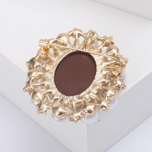 Macro detail of vintage oval brooch back with gold metal frame and secure pin closure