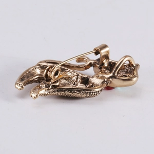 Vintage gold cat brooch featuring a safety pin closure and textured alloy finish