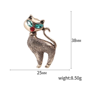 Vintage gold cat brooch with rhinestone eyes and detailed textured alloy finish