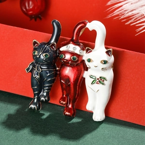 Three festive Christmas cat brooches with enamel finish and sparkling rhinestones