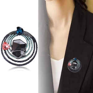 Vintage crystal glass brooch with blue rhinestones on black alloy shown on white and model