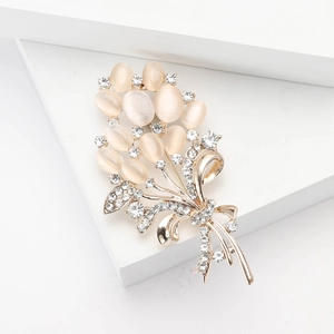 Elegant gold bouquet brooch with pink cat's eye stones and white crystal rhinestones