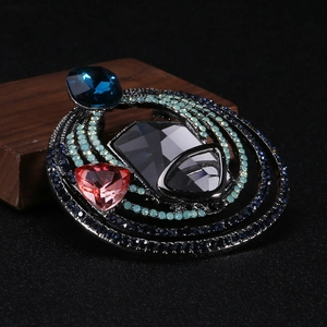 Macro detail of vintage crystal brooch with blue rhinestones and grey geometric gemstones