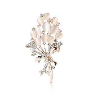 Elegant gold flower bouquet brooch with white opal stones and sparkling crystal accents