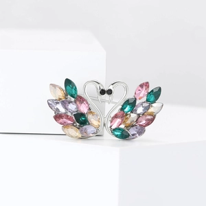 Detailed view of twin swan brooch with colorful marquise crystals and silver alloy base