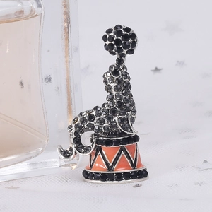 Sparkling circus dolphin brooch with black rhinestones and orange enamel detailing