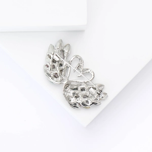 Detail view of silver swan brooch back with secure pin clasp and claw-set crystals