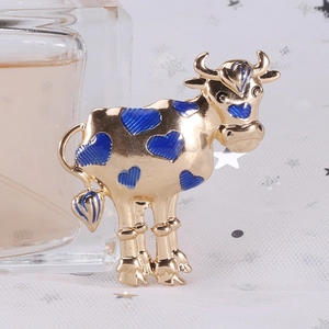 Detail of creative ox brooch featuring gold-plated alloy and blue heart enamel patterns