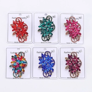 Detail view of colorful crystal flower brooches in six vintage rhinestone styles