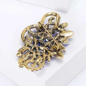Vintage floral crystal brooch in gold-plated alloy with deep blue marquise gemstones