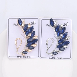 Detail of crystal swan brooches with navy gems and rhinestones on card display