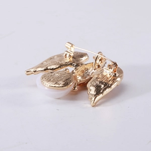 Retro eagle brooch back view showing golden wings and secure rotating pin fastener