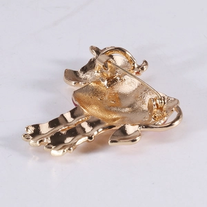 Back view of gold plated cow brooch showing secure pin fastener and textured metal finish