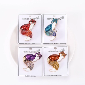 Macro detail of four fox brooches with colorful rhinestones on a display tray